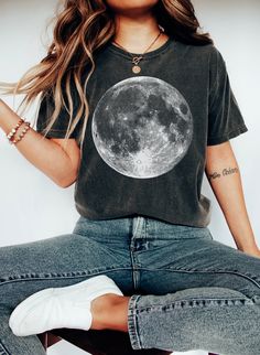 Experience the magic of the night sky with our stunning Crescent Moon t-shirt. Made from soft and comfortable cotton, this shirt features a beautiful graphic print of the Crescent Moon in all its glory. Perfect for stargazers, dreamers and spiritualists, this shirt is sure to become a favorite in your wardrobe. *Products/Material* Our T- shirts are super comfy and light. * 100% combed and ring-spun cotton* * Pre-shrunk * Side-seamed *Heather colors have varied fiber content. Our Sweatshirts are very soft and comfortable. * 50% cotton, 50% polyester * Pre-shrunk * Air-jet spun yarn with soft feel and reduced pilling * Double-needle stitched collar, shoulders, armholes, cuffs, and hem * Quarter-turned to avoid crease down to middle *Print* The Print is High quality Digital Print (DTG) using Celestial Moon Print Crew Neck T-shirt, Relaxed Fit Graphic Tee With Moon Print, Relaxed Fit Moon Print Graphic Tee, Black Celestial Crew Neck Top, Celestial Short Sleeve Tops With Moon Print, Black Short Sleeve Shirt With Moon Print, Black Celestial Graphic Print Top, Moon Phase Astrology, Celestial Shirt