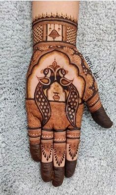 the hand is decorated with henna designs