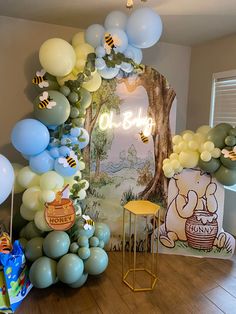 a room filled with balloons and winnie the pooh decorations