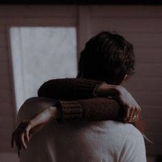 a man is holding his arm around another person's neck