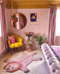 a bedroom decorated in pink and yellow with a lion rug on the floor