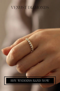 a woman's hand with a diamond ring on it and the words, buy wedding band now