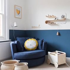 a child's room with a blue chair and toy car on the floor next to it