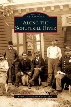 a group of men standing next to each other in front of a wooden building with the words along the schuyikill river written on it