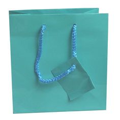 "Shipping to the Lower 48 US States only. Alaska Hawaii, PR, US Territories and APO addresses to contact us for actual shipping costs. Sold in Qty 100 Bags Gloss laminated art paper tote bag with a matching braided rope handle. This beautiful bag makes your packaging perfect when paired with tissue paper and a bow! Jewelry not included. Color: Teal Blue Size: Measures 6.5 \" x 3.5\" x 6.5\" tall. Product note: Make your packaging shine with glossy euro totes! Material: Teal paper" Blue Square Box Bag With Top Carry Handle, Light Blue Pouch Bag As Gift, Light Blue Pouch Bag For Gift, Blue Pouch Box Bag For Shopping, Blue Box Bag Pouch For Shopping, Blue Pouch Box Bag As Gift, Blue Box Bag For Shopping, Blue Square Bag For Gifts, Blue Square Bag For Gift