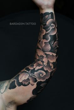 the arm is covered in black and white flowers