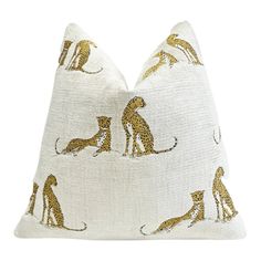 a white and gold pillow with leopards on it