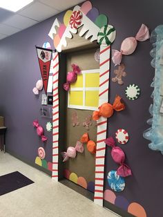 an office decorated for christmas with candy canes and paper decorations on the front door