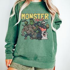 "Get into the spooky spirit with our \"Monster Mash\" Sweatshirt! This vintage-inspired Halloween design features all the Spooky Monsters on a comfy Comfort Colors sweatshirt. Embrace the Halloween vibes with this unique and fun Monster  Sweatshirt that's perfect for the season. Stay cozy and stylish while celebrating the spooktacular season!  All clothing and accessories from The Southern Thistle are handmade-to-order, just for you! ☺️ Our Gildan sweatshirt is made from a blend of 50% cotton and 50% polyester, ensuring comfort and durability. It features a classic fit with no center crease and a 1x1 athletic rib knit collar with spandex for added flexibility.  Experience ultimate comfort with our Comfort Colors shirt. Made from 9.5 oz. 80/20 ring spun cotton/polyester blend, this shirt of Halloween Cotton Pre-shrunk Sweatshirt, Pop Culture Screen Print Tops For Fall, Horror Style Long Sleeve Tops For Streetwear, Green Band Merch Top For Fall, Horror Graphic Print Long Sleeve T-shirt, Green Halloween Graphic Print Sweatshirt, Grunge Long Sleeve Halloween T-shirt, Pop Culture Tops With Character Print For Fall, Halloween Crew Neck Top With Graphic Print