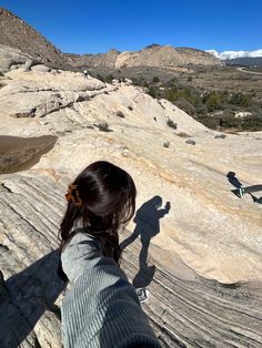 a person standing on top of a large rock