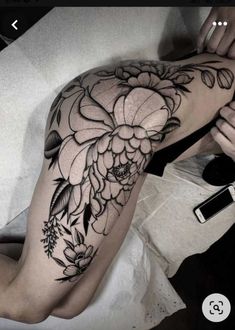 a woman's arm with flowers on it