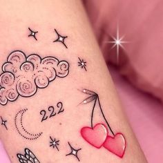 a tattoo on the leg of a woman with clouds, stars and hearts flying in the sky