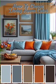 a living room with blue curtains and orange pillows on the couch, in front of a painting