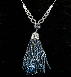 A striking dress jewellery vintage piece.  It's unusual, recycled and unique. The Tassel is tiny blue beads, fluid, sparkly and the chain, lovely in itself, i am informed is silver.  A very pretty ensemble.  Dimensions: Tassel - 8 cm long round  Chain and tassel total - 17.5 cm Silver Beaded Chain Necklaces As Gift, Blue Pendant Necklace For Evening, Silver Jewelry With Beaded Chain For Evening, Blue Beaded Necklaces For Evening, Elegant Blue Beaded Necklaces With Chain, Silver Beaded Chain Necklace For Evening, Silver Beaded Necklaces With Dangling Beads For Gifts, Handmade Blue Jewelry For Evening, Blue Beaded Evening Jewelry