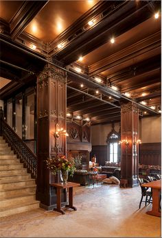 an ornately decorated lobby with stairs and chandeliers