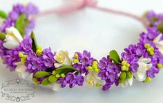 purple and white flowers are arranged on a headband