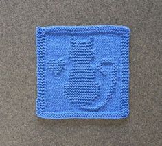 a blue crocheted square with an image of a fish on it's side