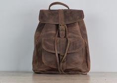 A comfortable  and stylish  women's leather backpack.  This  backpack is  handcrafted  from 100 % genuine leather. Perfect for occasional travel and day - to - day use.  One external pocket and one zipped pocket on the back side.  Metal buckle closure. Easy adjustable shoulder  leather straps.  NIce medium size backpack which is perfect for everyday use, work, school and travel. Unlined interior One roomy compartment On products can be small natural irregularities, like scars, stitches,  that pr Handmade Leather Backpack For Everyday, Everyday Handmade Satchel Backpack, Leather Backpack For Trips, Handmade Leather Backpack For Travel, Handmade Leather Satchel Backpack For Travel, Handmade Leather Travel Backpack, Handmade Backpack For Everyday Use, Handmade Travel Satchel Backpack, Handmade Travel Backpack