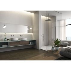 a modern bathroom with two sinks and a large mirror on the wall next to it