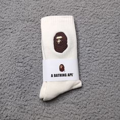 A Bathing Ape Crew Socks Embroidered Ape Head Logo Mens Womens Unisex Size: One Size Fits All Color: Cream White Brown Brand New In Packaging. Fast Shipping! 1 Day Shipping And Handling. White Breathable Cotton Socks, White Cotton Socks For Streetwear, White Cotton Socks, Cream Socks, Apparel Design Inspiration, Black Men Fashion Swag, 2024 Christmas, Streetwear Men, Bathing Ape