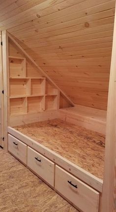 a loft bed with storage drawers underneath the roof and under the stairs to the second floor