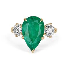 A stunning natural Colombian emerald and diamond three-stone ring. At the center is displayed a magnificent 5.74-carat natural Colombian pear cut emerald with vivid green color and visible Jardin and imperfections, making this stone a one of a kind. Accented are brilliant round diamonds (0.47-carats each) that definitely make a statement. The stones are set in a 18K yellow gold, prong setting. Turn heads everywhere you go with this beauty! Setting Style: Three-Stone Setting Material: 18K Yellow Timeless Green Three Stone Jewelry, Timeless Emerald Ring With Three Stones, Luxury Three Stone Emerald Jewelry, Emerald Three Stone Ring With Diamonds, May Birthstone Emerald Three-stone Diamond Ring, May Birthstone Emerald Ring With Three Diamonds, Three-stone Emerald Diamond Ring For May Birthstone, Yellow Gold Pear-shaped Three Stone Jewelry, Luxury Three-stone May Birthstone Jewelry