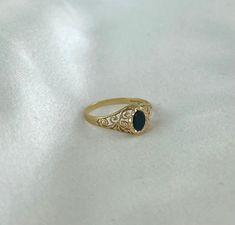 This charming black onyx ring with a detailed 9ct gold band is really sweet. With the black onyx stone flanked by pretty detailing on the shoulders of the ring, your eye is drawn to the lovely stone. The band itself is made of 9ct yellow gold and tapers down to a slender band after the detailing of the shoulders. The ring is fully hallmarked and in good condition. Size: O UK Weight: 1.2g Metal: 9ct gold Stones: Black onyx stone 5mm high and 3mm wide Hallmarks: '375', Birmingham assay stamp The r Victorian Black Engraved Ring In 14k Gold, Classic Black Engraved Promise Ring, Black 14k Gold Hallmarked Engraved Ring, Black 14k Gold Engraved Ring, Black 14k Gold Engraved Signet Ring, Black Engraved 14k Gold Ring, Elegant Black Hallmarked Enamel Ring, Classic Black Engraved Ring Stamped 14k, Classic Black 14k Gold Engraved Ring