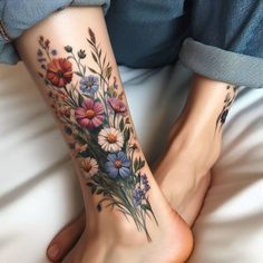 a woman's foot with flowers on it and the bottom part of her leg