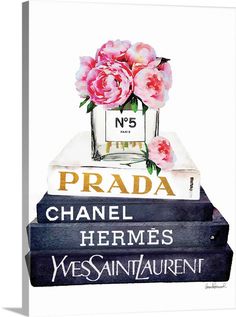 three books stacked on top of each other with pink flowers in the middle, and one book that says prada