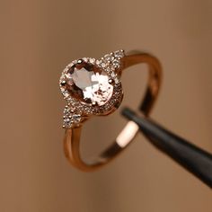 It is a (morganite) ring. The main stone is (6 mm*8 mm oval cut).weight about (1.13) carats.The basic metal is sterling silver and plated with rhodium/14k white  gold/14k rose gold/14k yellow goldYou can also go to my shop Home for more elegant rings: https://www.etsy.com/shop/godjewelry?ref=hdr_shop_menu Customization is always welcome and please feel free to contact with me if you have any design ideas! Oval Rose Gold Diamond Ring With Gemstone, Oval Rose Gold Diamond Ring, Elegant Oval Rose Gold Topaz Ring, 14k Rose Gold Oval Jewelry In Pink Gold, Oval 14k Rose Gold Jewelry, Oval 14k Rose Gold Jewelry In Pink Gold, 14k Rose Gold Ring With Oval Shape, Oval Diamond Ring In Rose Gold, Morganite Diamond Ring In Rose Gold For Promise