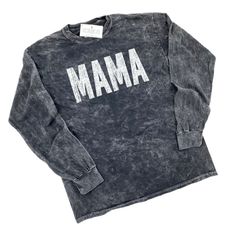 MAMA Mineral Wash Long Sleeve Shirt Professionally screen printed. Shirt color is Black Mineral Wash. Print color is White. Please allow for slight color variation from the example pictured as no 2 garments are exactly the same due to the unique mineral wash process. Made of 100% heavyweight cotton. Adult unisex sizing - please note these mineral wash shirts run slightly more fitted than our standard adult unisex tees. If you are in between sizes or like a more relaxed fit, we recommend ordering Unisex Black Tops With Name Print, Black Relaxed Fit Top With Name Print, Black Long Sleeve Soft-washed T-shirt, Black Long Sleeve Soft-washed Tops, Black Soft-washed Long Sleeve Tops, Unisex Letter Print Tops For Fall, Fall Crew Neck T-shirt With Name Print, Unisex Screen Print Crew Neck Top, Cotton Sweatshirt With Name Print