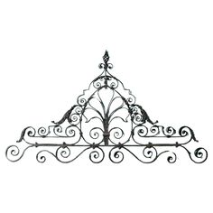 an iron shelf with ornate designs on the top and bottom, against a white background