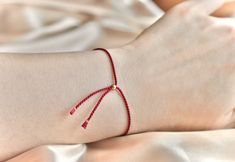 "Real silk Red String Bracelet with 14KT Gold Filled or Sterling Silver hardware  This Red String bracelet is a gorgeous bolero style tasseled bracelet made with 1mm real silk rope strand and hardware 100% in whichever metal you choose. Red String Bracelet details: + Silk, 1mm, rope strand, 2 tassel pull ends + Cinched shut adjusting bead cap + One size fits all with adjustable fastening up to 9.5 inches The Red String bracelet is a traditional protection + good luck talisman and also worn by a Elegant Red Bracelets For Good Luck, Traditional Jewelry With Sliding Knot For Gifts, Traditional Sliding Knot Jewelry As Gift, Elegant Red Jewelry With Sliding Knot, Ward Off Evil Eye, Protection Ward, Beaded Diy, Bolero Style, Tom Y Jerry