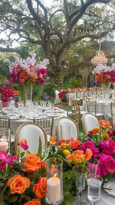 the tables are set up with candles and flowers on them for an elegant wedding reception