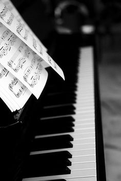 sheet music is sitting on top of the piano keys and it's been folded up