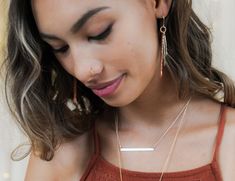 Embrace the subtle charm of our meticulously handcrafted Layered Mini Bar Necklace—an embodiment of understated elegance and timeless sophistication. Crafted with care by our skilled artisans, this empowering piece of jewelry is designed with a touch of magic, capturing attention with just the right amount of allure. Crafted from fine metal, this necklace features a slender width of 1/8", providing a barely-there feel against your skin. The delicate hand-hammered texture adds a unique charm, enh