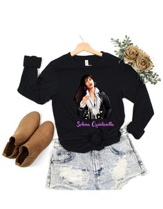 a black shirt with an image of a woman wearing a white blouse and denim shorts