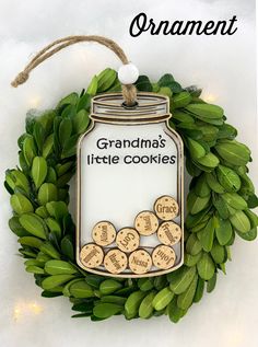 an ornament hanging on a wreath that says grandma's little cookie cookies