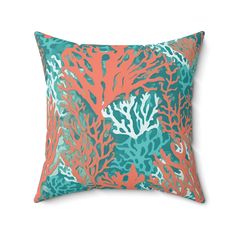 an orange and blue pillow with corals on it