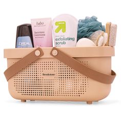 a basket filled with personal care items on top of a white surface and brown handles