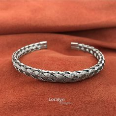 You will love this amazing bracelet crafted from 5 small stainless steel wires braided in a spiral pattern. The smooth 1/4 inch wide braid is finished at each end with with rounded stainless steel caps to ensure nothing will catch on your clothes or scratch your skin. The round braid design makes the bracelet flexible which allows you to easily expand the opening while maintaining its shape. In total the length of the bracelet is 7 inches and I recommend for wrists sizes 6.5 to 9 inches. Since i Boyfriend Bracelet, Round Braid, Silver Braided Bracelet, Wire Cuff Bracelet, Woven Metal, Bracelets For Boyfriend, Wire Cuff, Braid Designs, Mens Bracelet Silver