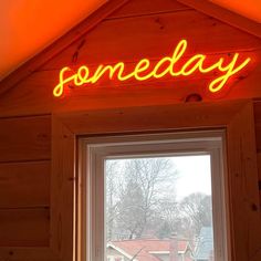 a neon sign that reads somebody above a window