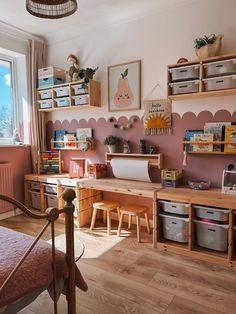 a child's bedroom with pink walls and wooden shelves on the wall next to a bed