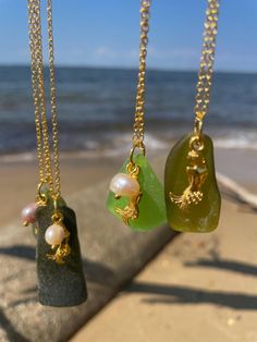 Beautiful, one of a kind sea glass mermaid pendant necklaces. Every piece of glass is different and unique, so no two necklaces are the same. The pictures in the listing are examples of what you can expect to receive when you purchase a necklace. Available on silver or gold chains, with matching mermaid and pearl charms. All the different shades of green sea glass  come to life when they are worn in the sun light. Perfect for any beach babe or coastal cowgirl. ️🫶 *All glass is personally sourced by me from the shores of the Chesapeake Bay. No two pieces are alike! Pictures here are examples only and are not necessarily the exact pieces you will receive! Enjoy your one of a kind piece!* Ocean-inspired Charms Necklaces For Gifts, Ocean-inspired Charms Necklace As Gift, Ocean-inspired Charms Necklace For Gift, Unique Handmade Sea Glass Necklaces, Handmade Unique Necklace With Sea Glass, Ocean-inspired Recycled Glass Jewelry As Gift, Gold Necklace With Recycled Glass For Gifting, Gold Necklace With Recycled Glass For Gifts, Handmade Ocean-inspired Sea Glass Necklaces