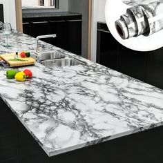 a kitchen counter top that has been painted black and white with colorful objects on it