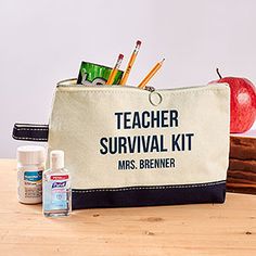 a teacher survival kit sits on a table next to an apple and other school supplies