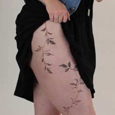 a woman with tattoos on her thigh