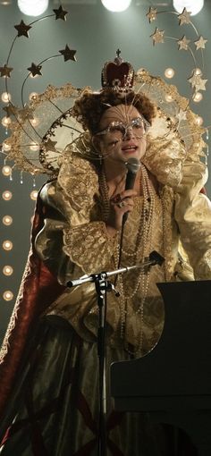 a woman in costume standing at a microphone