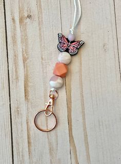 Keep your name tag or ID close to you with this pink butterfly silicone bead lanyard. Made with a breakaway clasp and silver colored metal swivel clip.  Lanyard length is approximately 20 inches from the breakaway clasp to the top of the swivel clip (where the beads attach). Length can be adjusted to be shorter by tying another knot inside the breakaway clasp.  Want a custom color or pattern? Please message me or email me at sincerelyjenn031@gmail.com *Contains small parts that can be a hazard f Pink Beaded Lanyards For Gifts, Pink Lanyards With Keychain For Everyday Use, Pink Lanyard With Keychain For Everyday Use, Handmade Pink Lanyards For Everyday Use, Pink Lanyard With Keychain For Gift, Pink Lanyard With Key Leash For Gift, Pink Lanyard With Keychain For Personal Use, Pink Lanyard With Keychain, Handmade Pink Lanyards For Personal Use