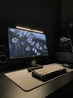 a computer monitor sitting on top of a desk next to a keyboard and mouse pad